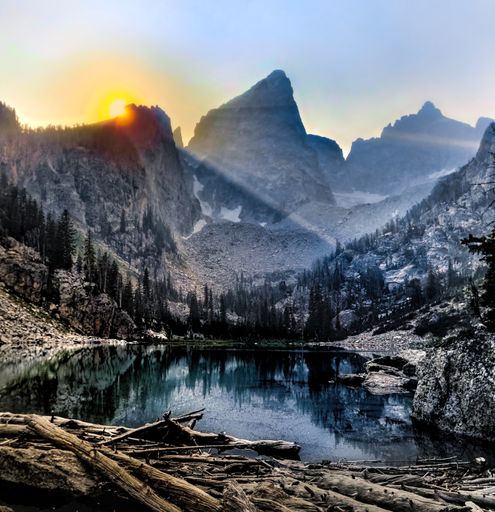 A scenic view of a sunrise over Delta Lake at the Grand Teton National Park in Wyoming, USA