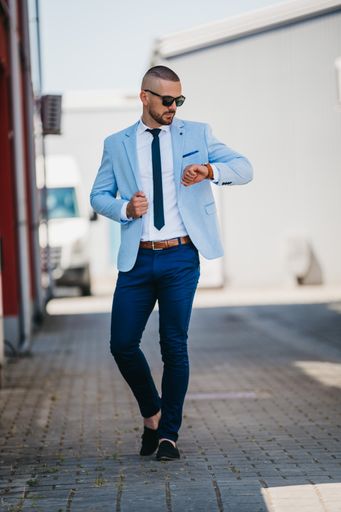 A vertical shot of a handsome young man in a suit with a business look