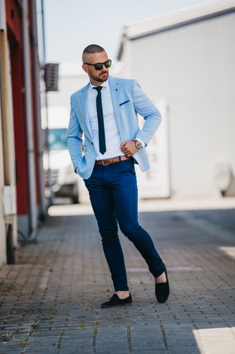 A vertical shot of a handsome young man in a suit with a business look