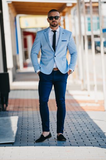 A vertical shot of a handsome young man in a suit with a business look