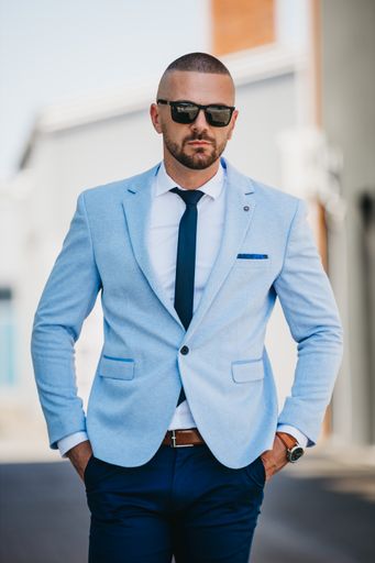 A vertical shot of a handsome young man in a suit with a business look