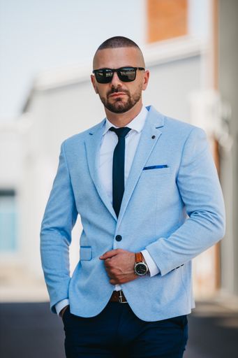 A vertical shot of a handsome young man in a suit with a business look