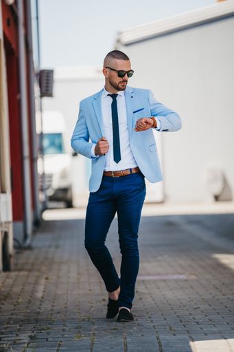 A vertical shot of a handsome young man in a suit with a business look