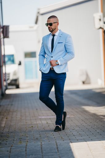 A vertical shot of a handsome young man in a suit with a business look