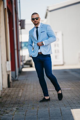 A vertical shot of a handsome young man in a suit with a business look