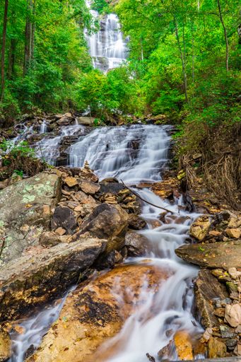 A scenic waterfall cascading through lush green forest in Amicalola Falls State Park, Georgia, USA.