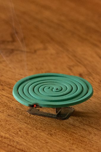 A closeup shot of a mosquito killer spiral on a wooden background