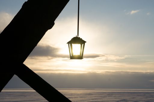 A scenic view of a lantern hanging on a sunny sky background