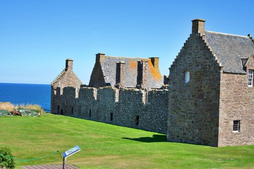 The ruins of Dunnottar Castle on Scotland's North Sea coast under a clear sky