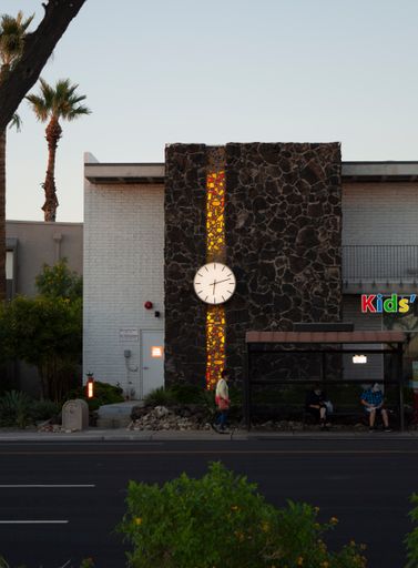 An illuminated clock on the side of a building in Phoenix, USA