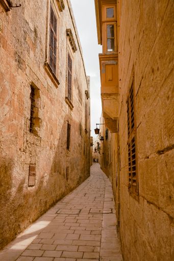 A narrow path in between stone houses