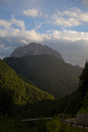 A vertical shot of beautiful green mountains and hills under a bright sky