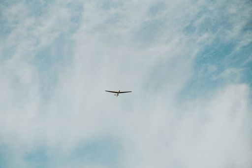 A low angle shot of an aircraft in a cloudy sky