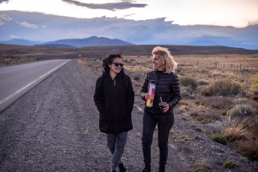 The Caucasian and Hispanic females walking near the highway and drinking yerba mate in Argentina