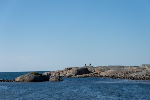 A panoramic shot of stony island surrounded by sea on a sunny day