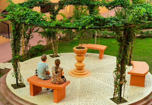 A scenic view of a young couple sitting in a park