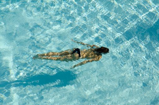 A woman swimming in crystal clear water