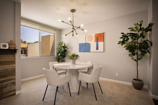 Modern condo featuring an upgraded kitchen, elegant interiors, private balcony with courtyard views, and access to pool and resort-style amenities.
