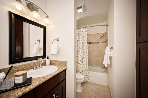 Modern condo featuring an upgraded kitchen, elegant interiors, private balcony with courtyard views, and access to pool and resort-style amenities.