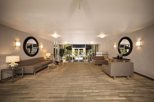 Modern condo featuring an upgraded kitchen, elegant interiors, private balcony with courtyard views, and access to pool and resort-style amenities.