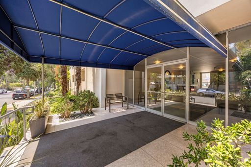 Modern condo featuring an upgraded kitchen, elegant interiors, private balcony with courtyard views, and access to pool and resort-style amenities.