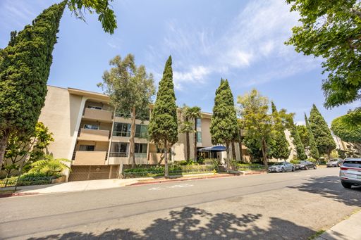 Modern condo featuring an upgraded kitchen, elegant interiors, private balcony with courtyard views, and access to pool and resort-style amenities.