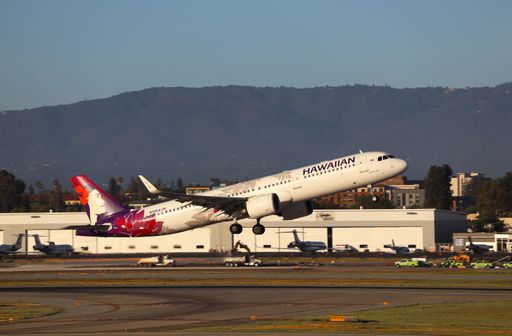 The Hawaiian Airlines A321 neo taking off with mountains in the background