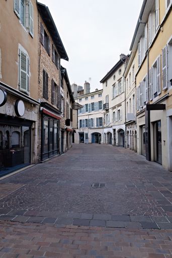 A quaint European street with cobblestone pavement and historic architecture, showcasing charming buildings