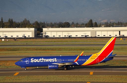 The Southwest Airlines Boeing 737-800 taxiing at San Jose airport with Santa Cruz mountains in the background