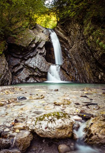 A beautiful waterfall from the rocks in a forest