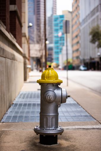 A vertical shot of a Fire Hydrant in a street