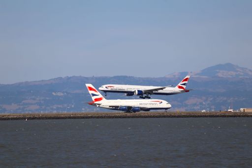 The British Airways Boeing 777-300 ER lands at San Francisco airport, with an Airbus A380 in the background.