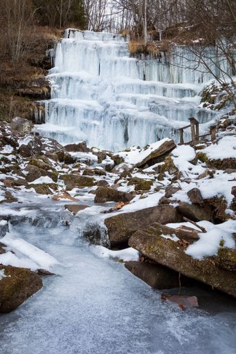 A vertical shot of famous Tupavica frozen waterfall (Stara Planina) over the Old mountain in Serbia