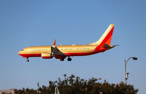The Southwest Airlines Boeing 737 MAX 8 in retro livery landing at San Jose airport.