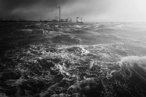 An amazing  grayscale aerial shot of a stormy seascape