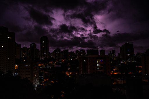 An amazing shot of a cityscape on dark clouds and lightning background