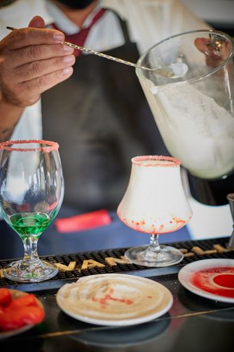 A vertical shot of a pina colada cocktail preparation in a Havana bar