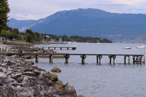 An old empty wooden deck over the lake under a blue cloudy sky during the daytime
