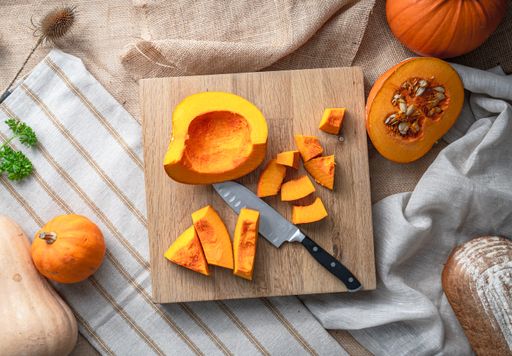 A top view of the makings of a delicious pumpkin soup and bread