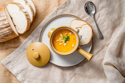 A top view of delicious pumpkin soup and bread