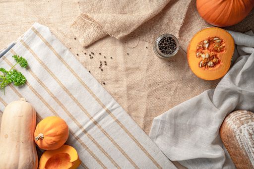 A top view of the ingredients fordelicious pumpkin soup and bread