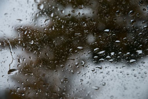 A closeup of waterdrops on the window glass
