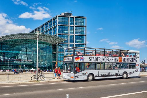 Hop on hop off bus near the Hauptbahnhof in downtown Berlin. In the background you can see the entrance of the Hauptbahnhof.