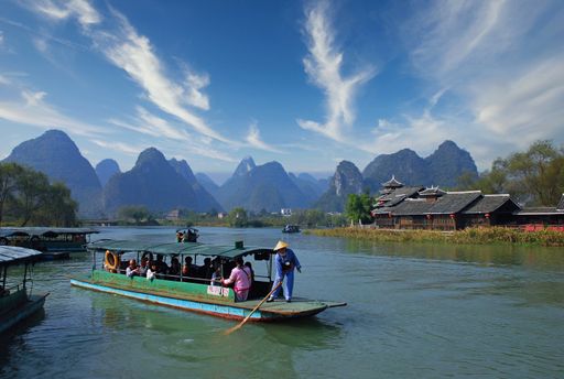 A closeup shot of tourists immersed in the boat ride along the river in Guilin, China