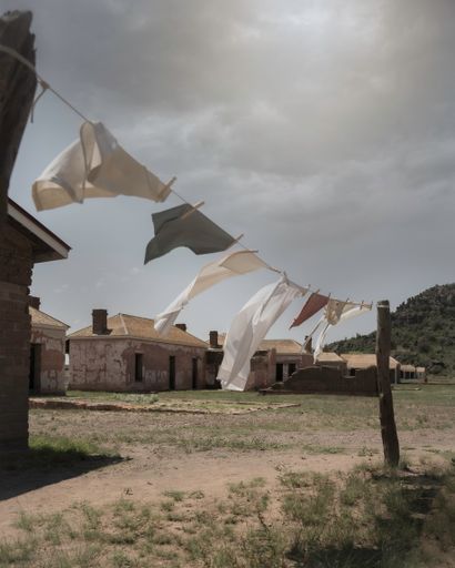 A vertical shot of laundry getting dried on a washing line in a small village