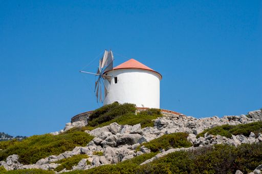 A traditional white windmill on the top of the hill in Mykonos, Greece