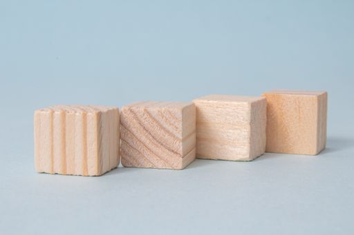 Four wooden cubes without icons on a blue background