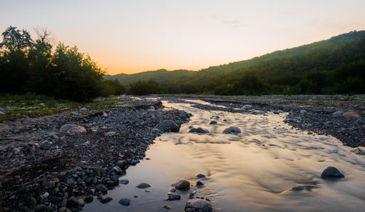 A stony mountain creek during sunset