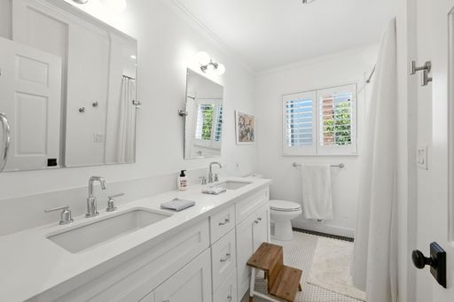 An interior design of a modern bathroom in white hues