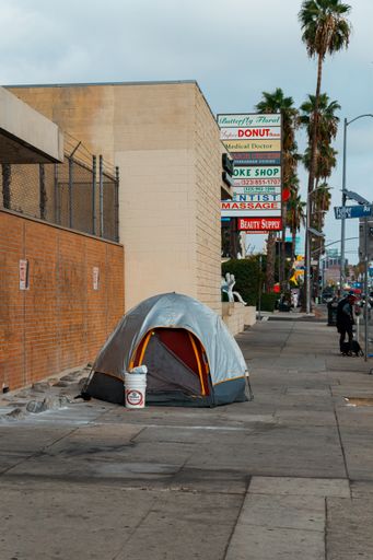 The vertical shot of a homeless person's tent in the middle of the alley